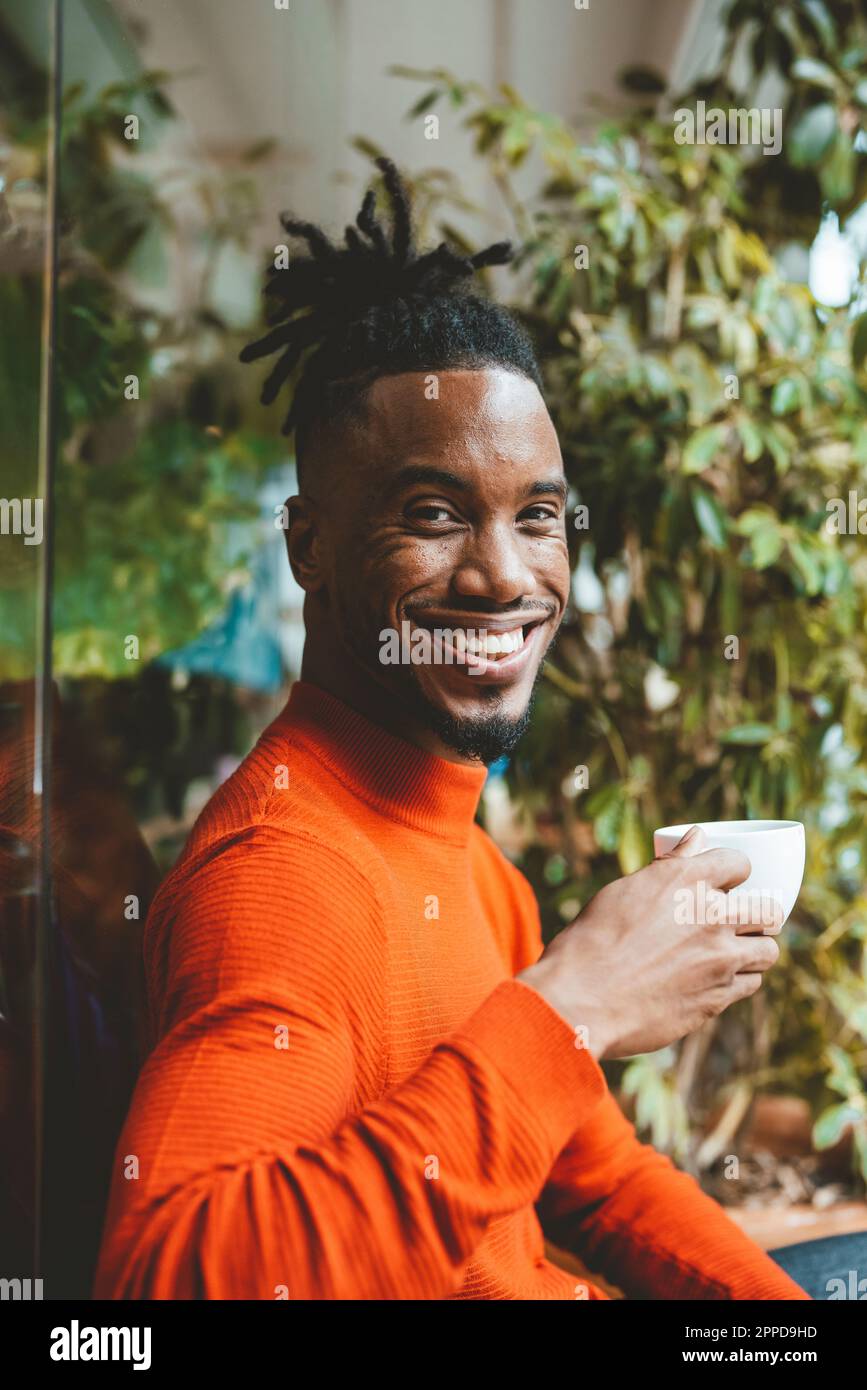 Happy young man holding coffee cup Stock Photo