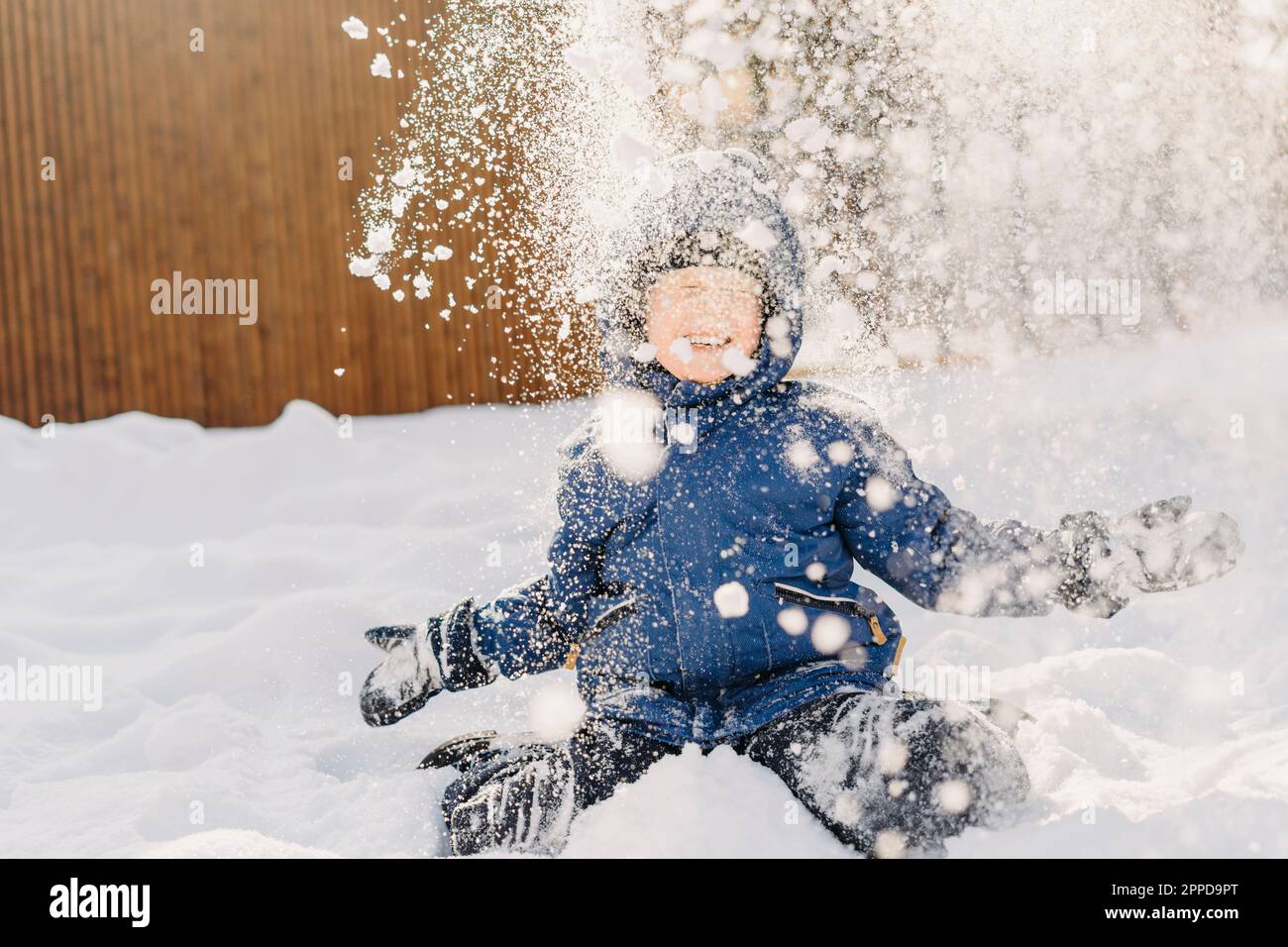 Happy boy enjoying in snow Stock Photo