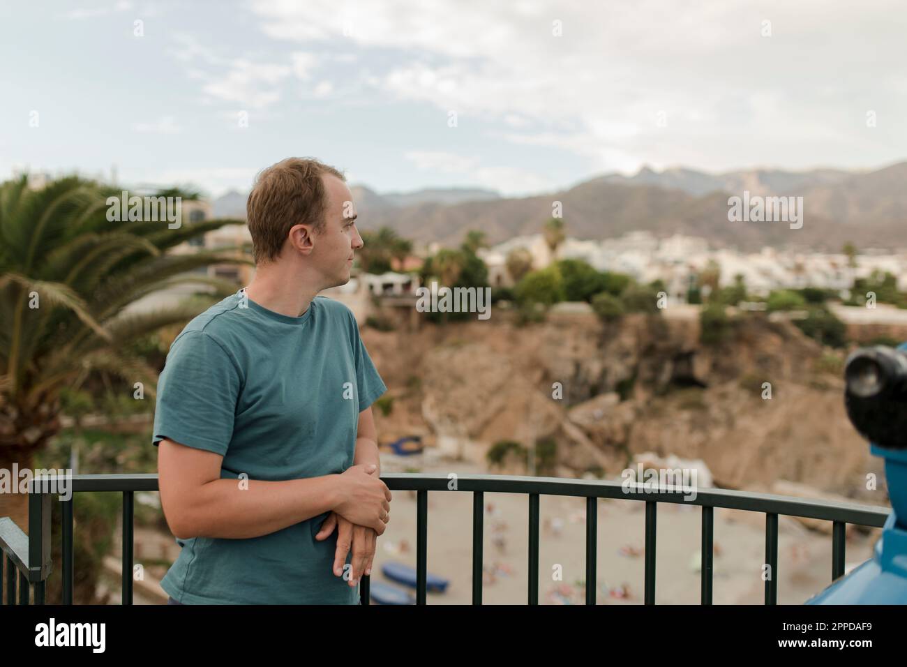 Thoughtful man standing by railing Stock Photo