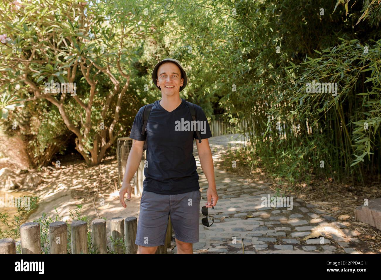 Happy man standing at footpath in park Stock Photo