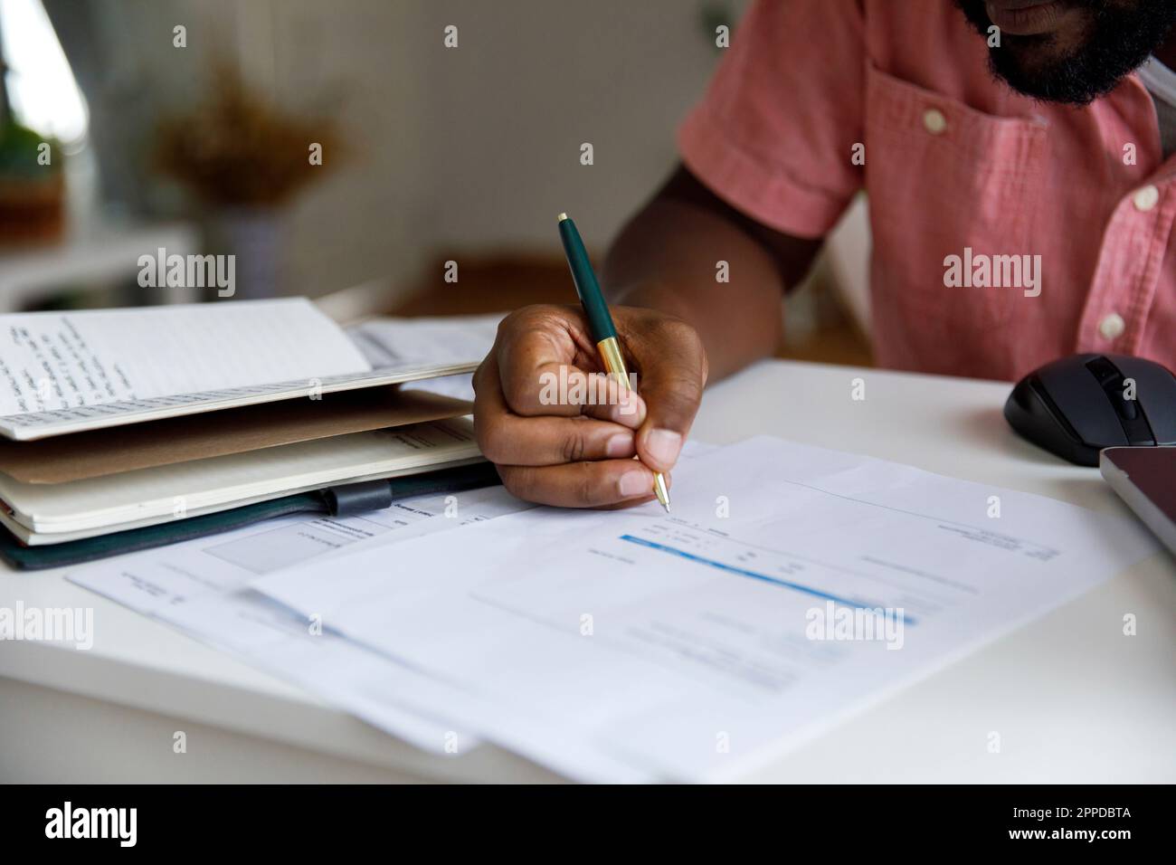 Freelancer calculating bills at desk in home Stock Photo Alamy