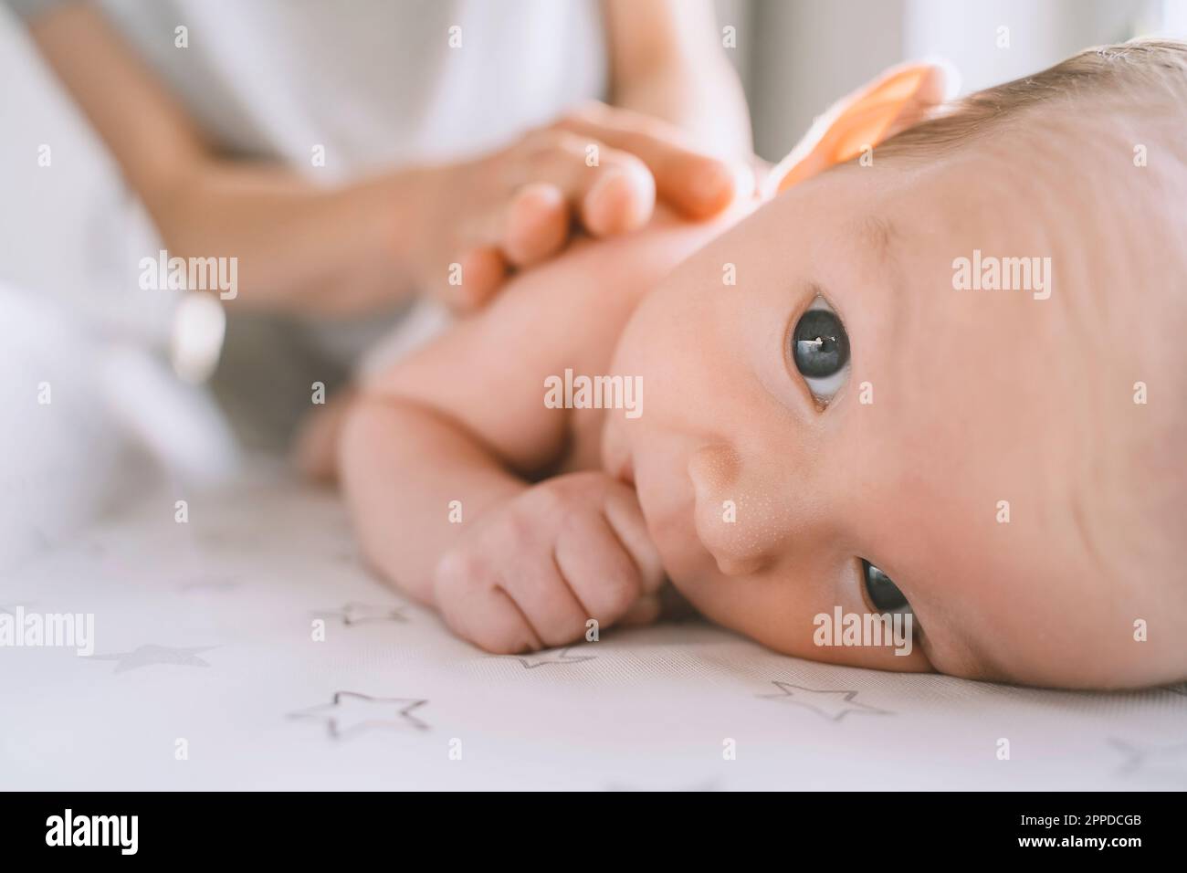 Mother changing diaper of baby boy on changing table Stock Photo Alamy