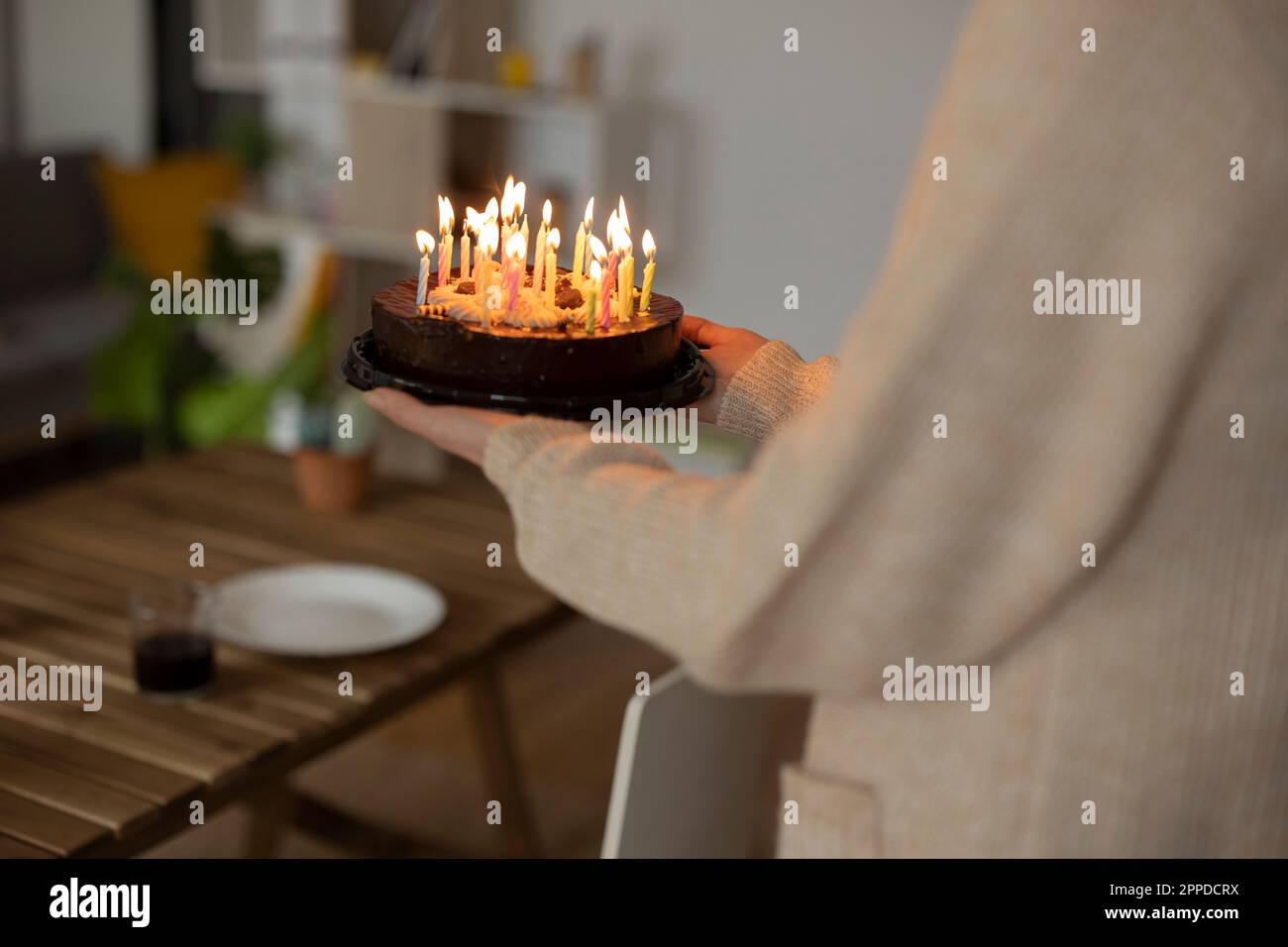 Woman holding birthday cake at home Stock Photo - Alamy