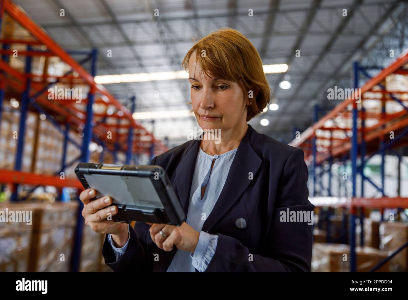 Mature manager using tablet PC at warehouse Stock Photo