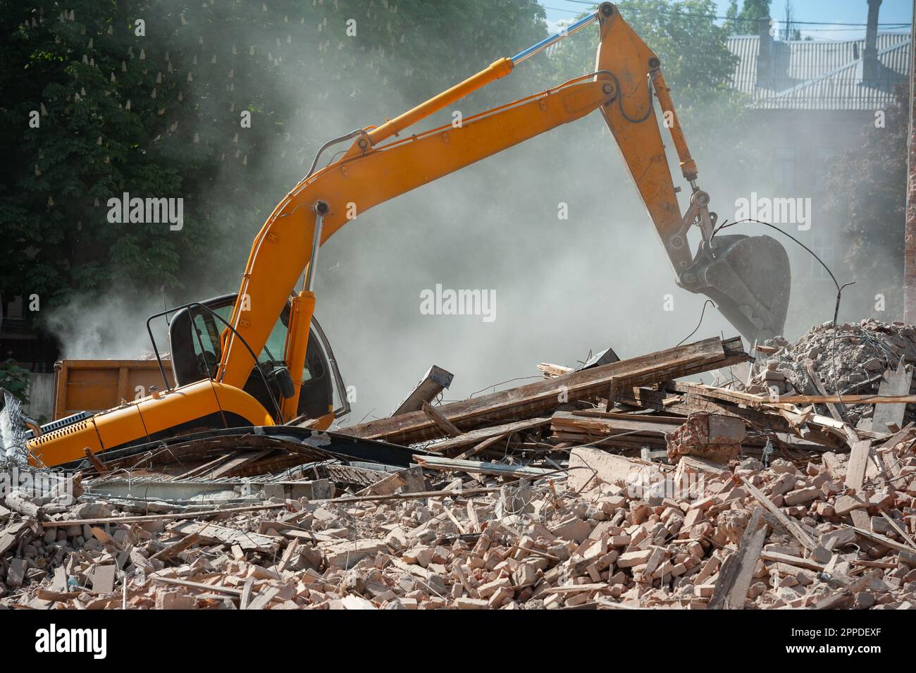 Demolition of building. Excavator breaks old house. Freeing up space