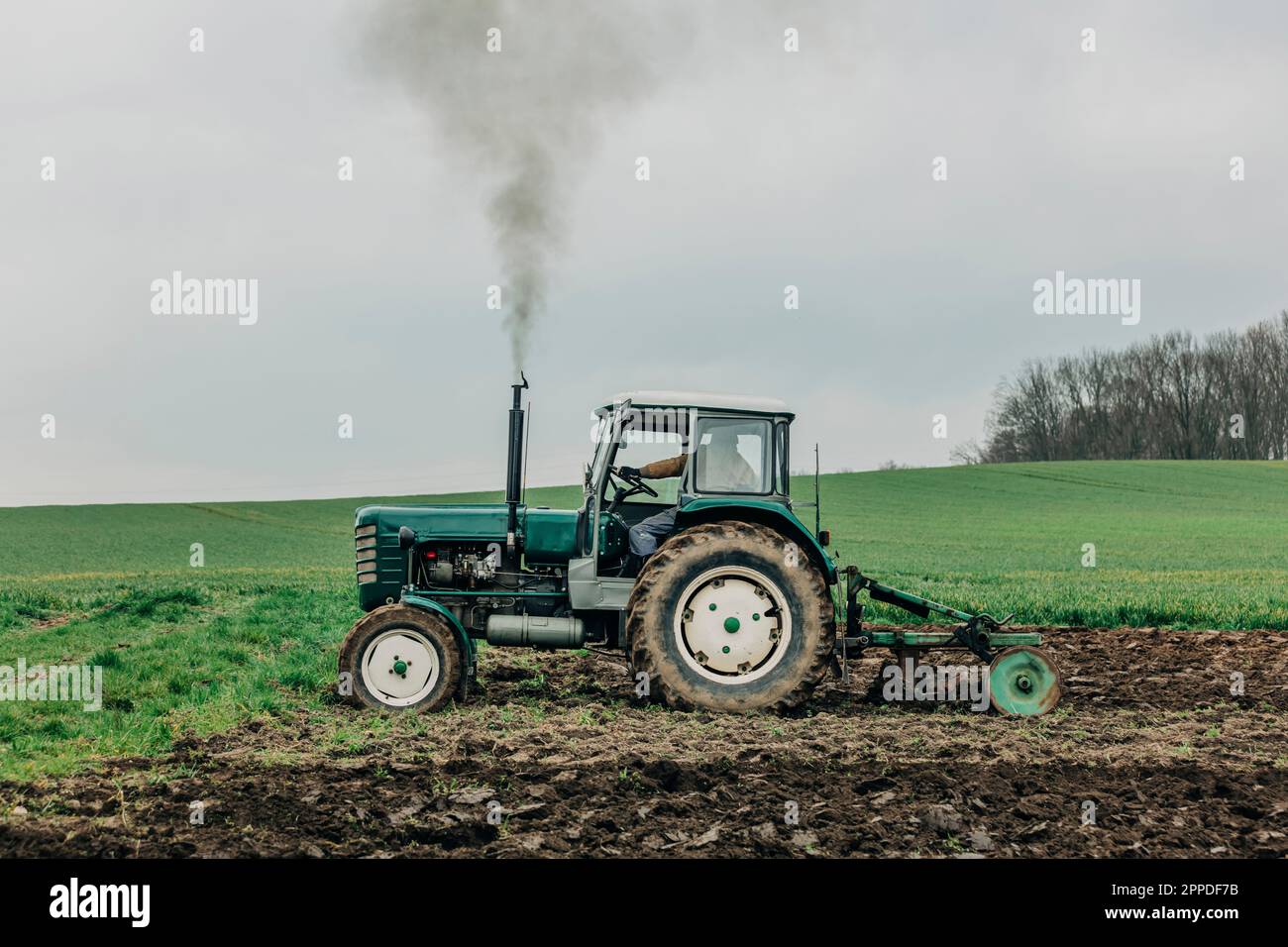Farmer Ploughing Field With Tractor Stock Photo Alamy