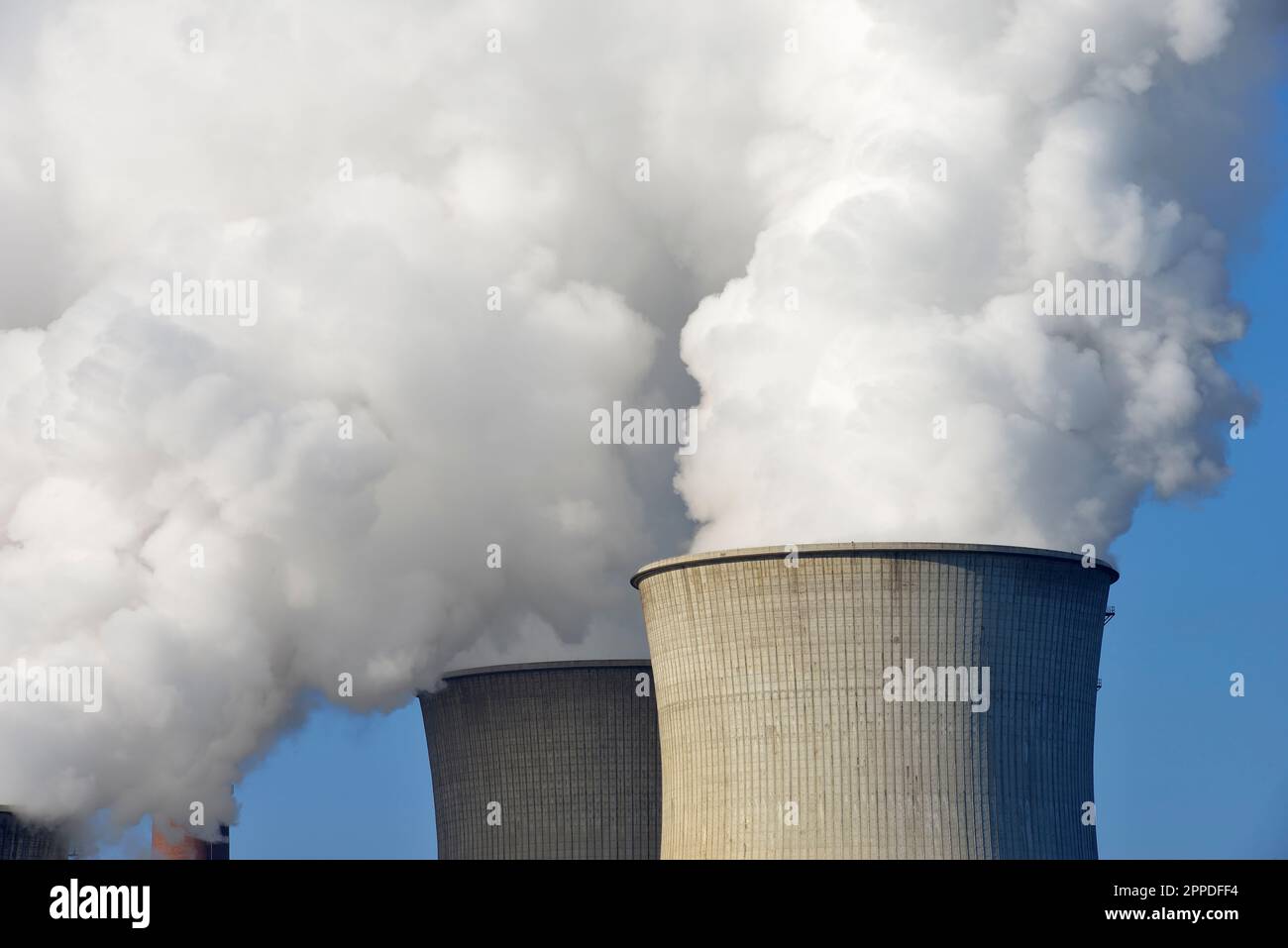 Germany, North Rhine Westphalia, Neurath, Cooling towers releasing clouds of water vapor Stock Photo