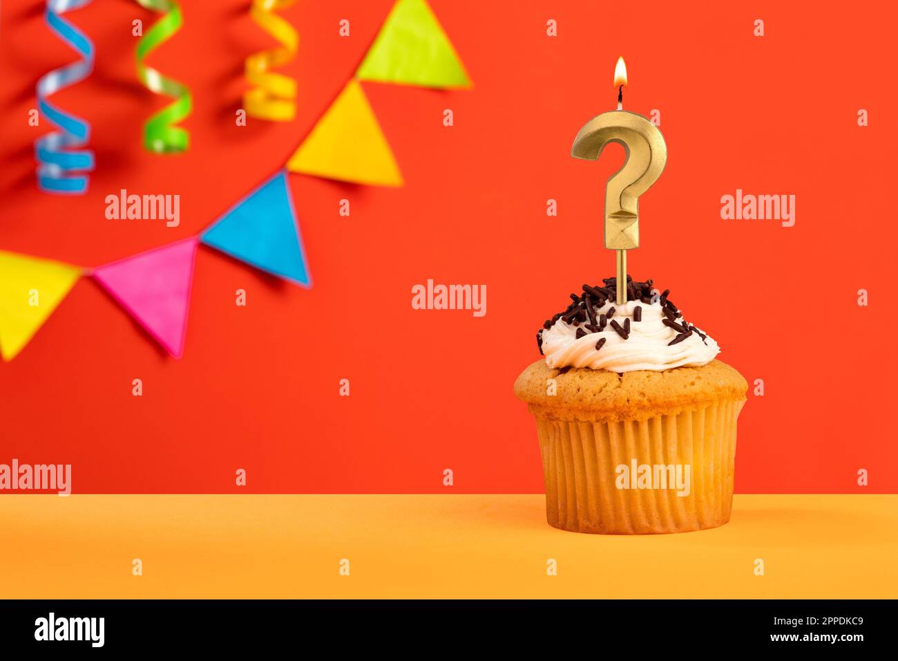 Question mark candle Birthday cake on orange background with bunting