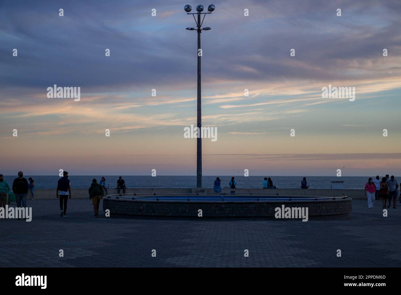 Necochea, Buenos Aires, Argentina. January 19, 2021. Center view point of to the sea, with silhouettes of people looking the ocean Stock Photo
