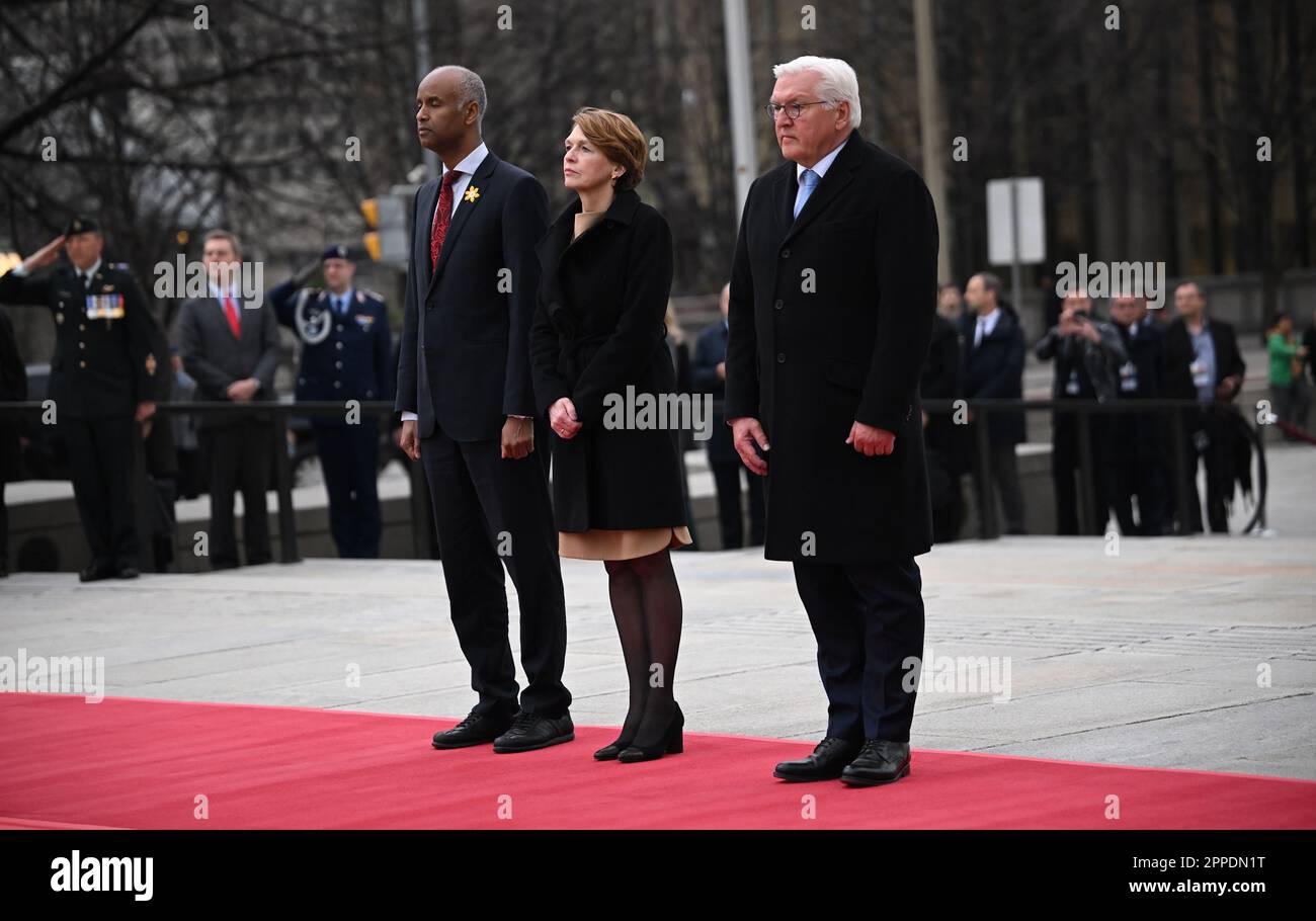 Ottawa, Canada. 23rd Apr, 2023. German President Frank-Walter Steinmeier (r) lays a wreath at the Tomb of the Unknown Soldier at the Confederation Square National War Memorial. His wife Elke Büdenbender and Ahmed Hussen, member of the Canadian House of Commons stand before him. The aim of the trip is to strengthen German-Canadian relations in difficult political and economic times. Credit: Britta Pedersen/dpa/Alamy Live News Stock Photo