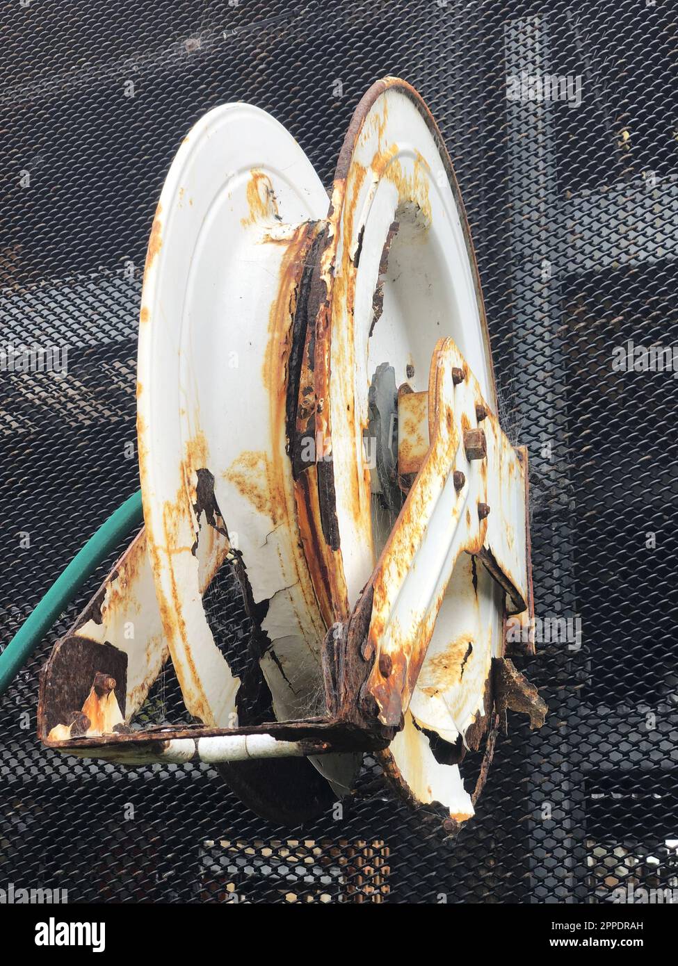 Rusted garden hose reel Stock Photo Alamy