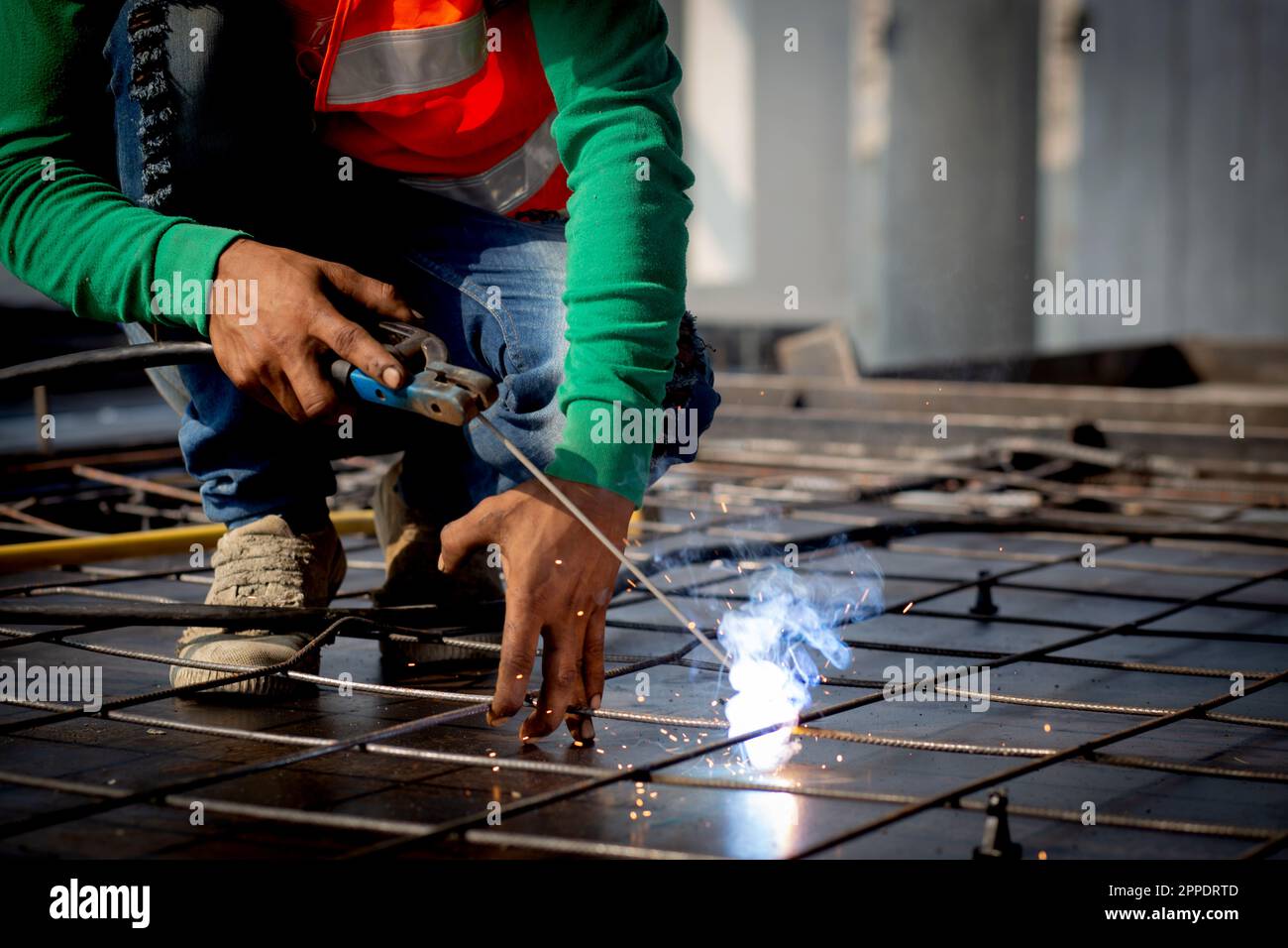 Closeup hands young worker using machine welding iron with hands