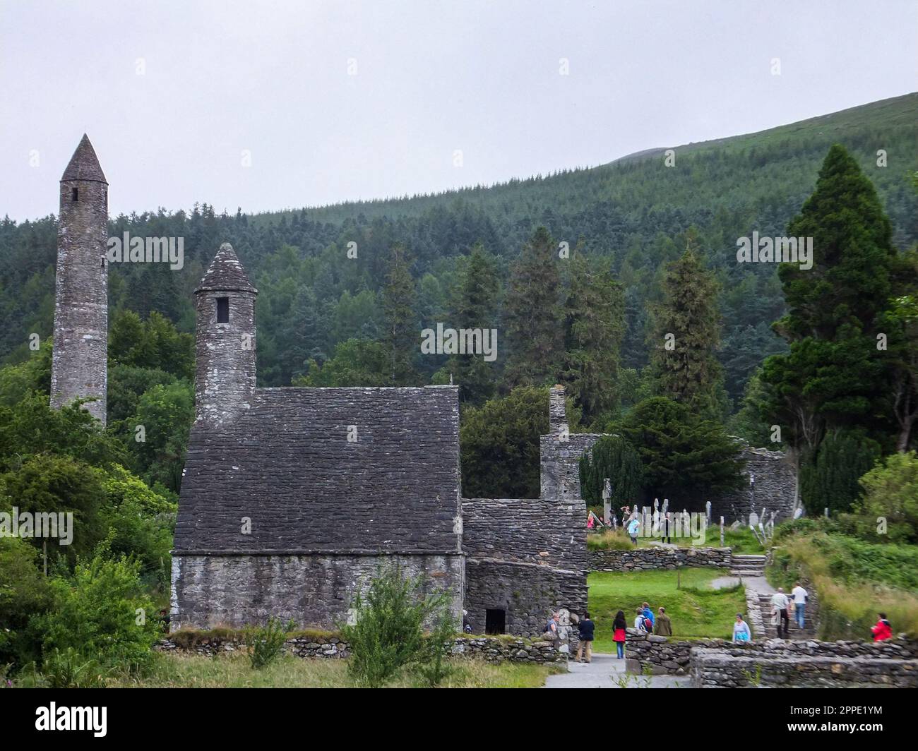 The ancient ruins of the Glendalough Monastic City, including the Round Tower and Saint Kevin's Kitchen, in Wicklow Mountains National Park, Ireland. Stock Photo