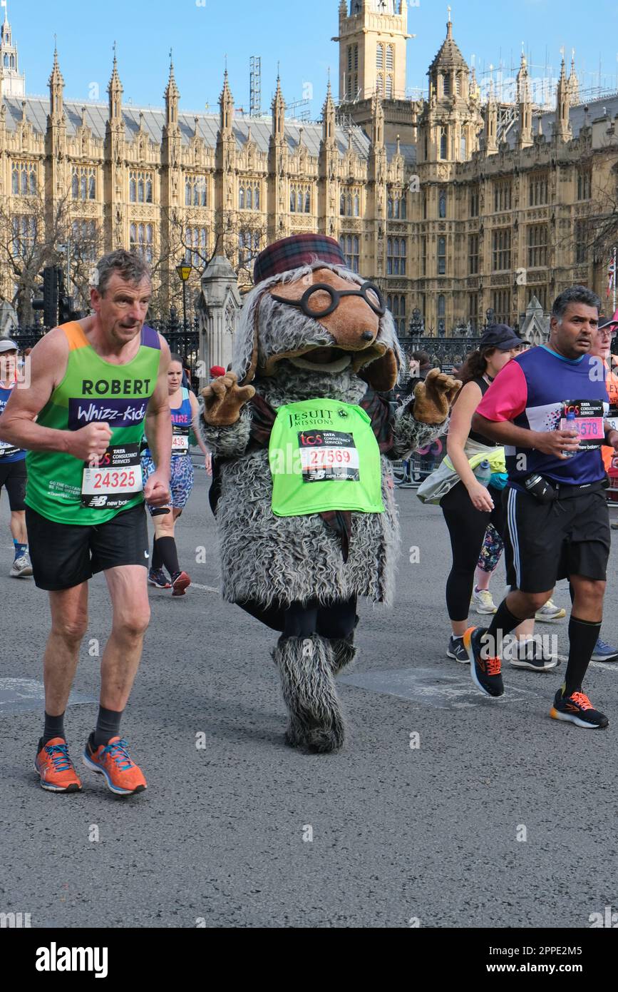 London, UK. 25th March, 2023. A fun runner dresses as a womble. Marathon runners are almost at the end of their journey reaching Parliament Square. Six hours after the event began, a steady stream of runners are still passing through. Credit: Eleventh Hour Photography/Alamy Live News Stock Photo
