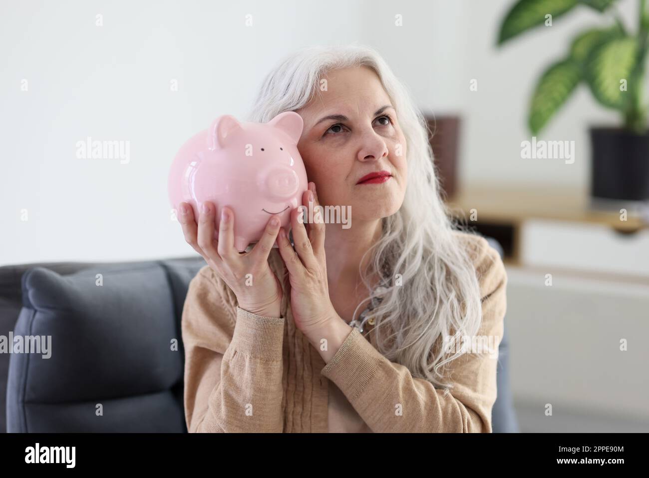 Mature woman happy piggy bank hi-res stock photography and images - Alamy