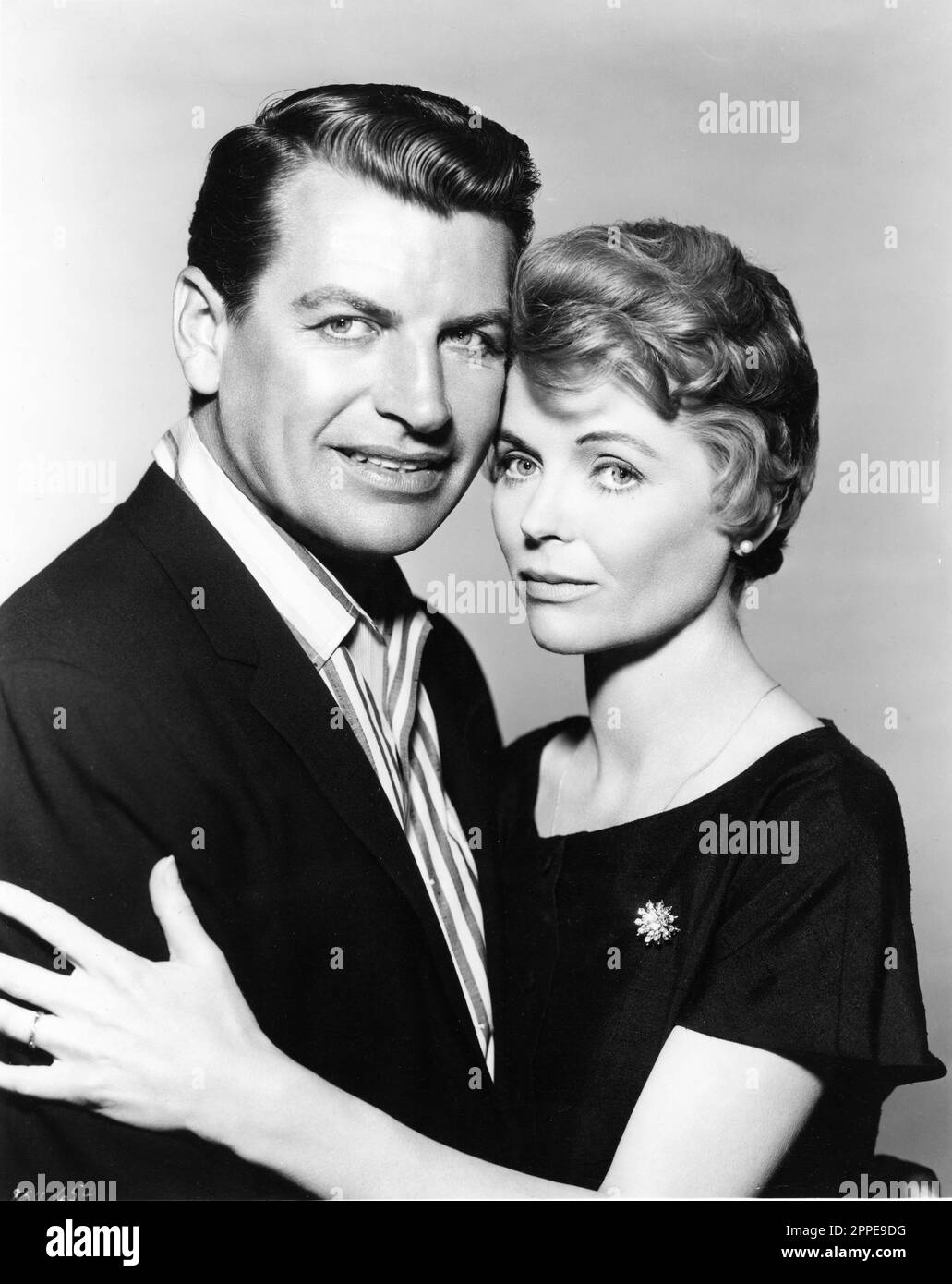 RICHARD EGAN and DOROTHY McGUIRE Portrait in A SUMMER PLACE 1959 director / screenplay DELMER DAVES novel Sloan Wilson music Max Steiner costume design Howard Shoup Warner Bros. Stock Photo