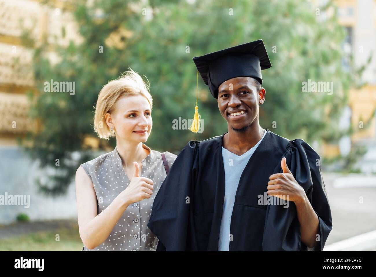 Woman graduation success thumbs hi-res stock photography and images - Alamy