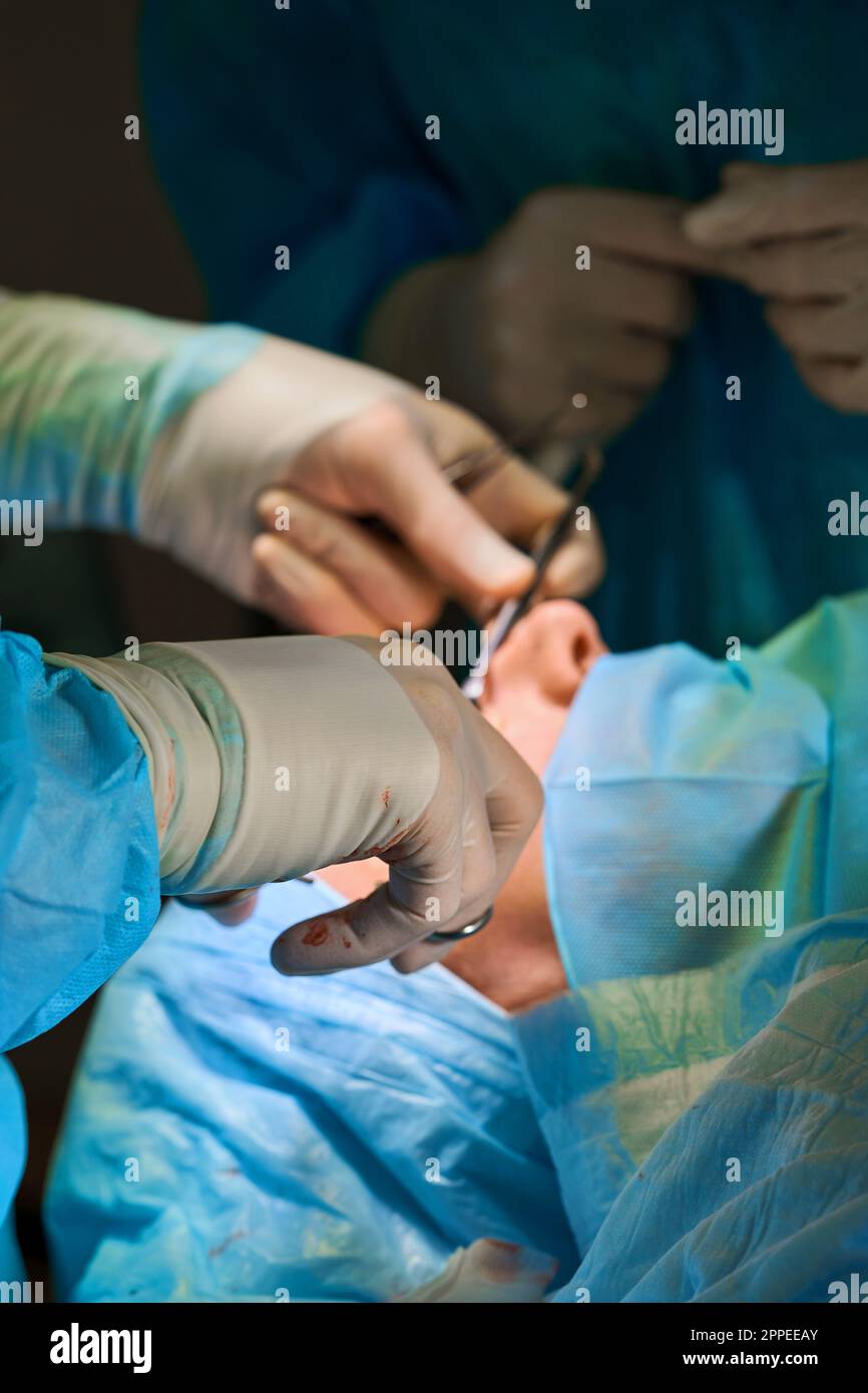 surgical instruments in the hands of a doctor close-up Stock Photo - Alamy