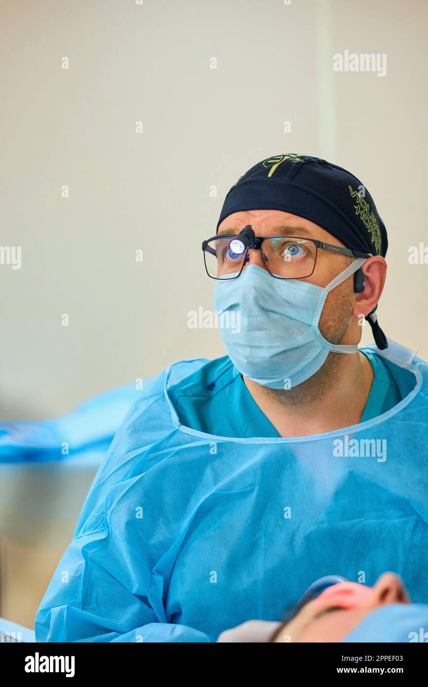 plastic surgeon operates on a patient in the operating room Stock Photo