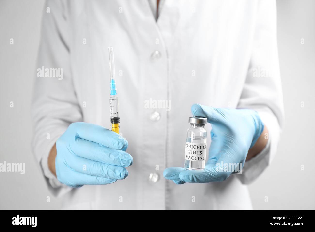 Chickenpox Doctor Doctor holding chickenpox vaccine and syringe, closeup. Varicella virus ...