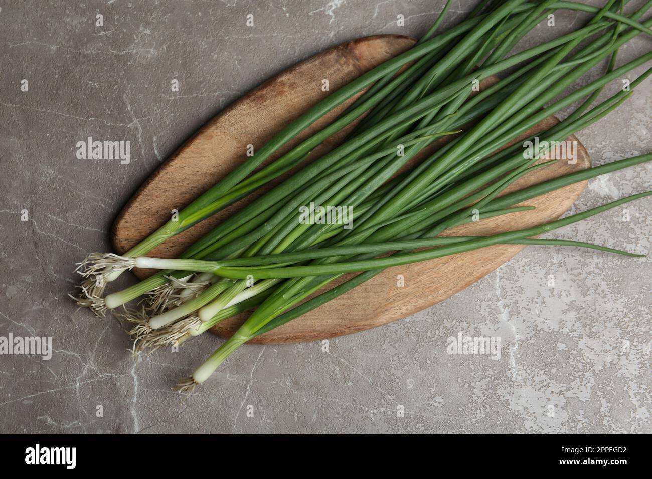 Fresh green spring onions on grey marble table, top view Stock Photo ...