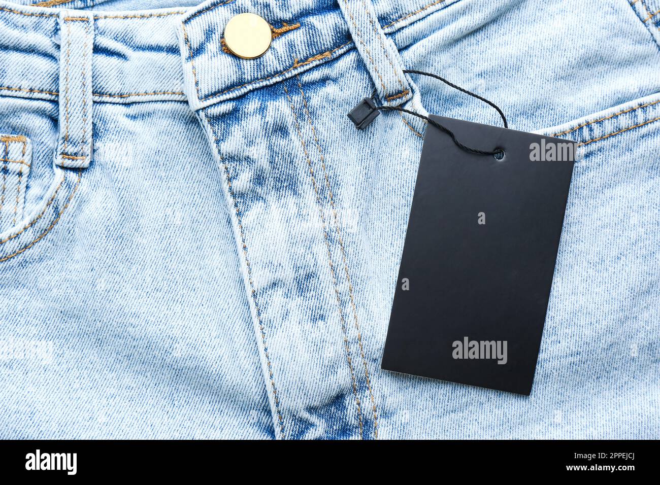 Blank tag on jeans, top view. Space for text Stock Photo Alamy