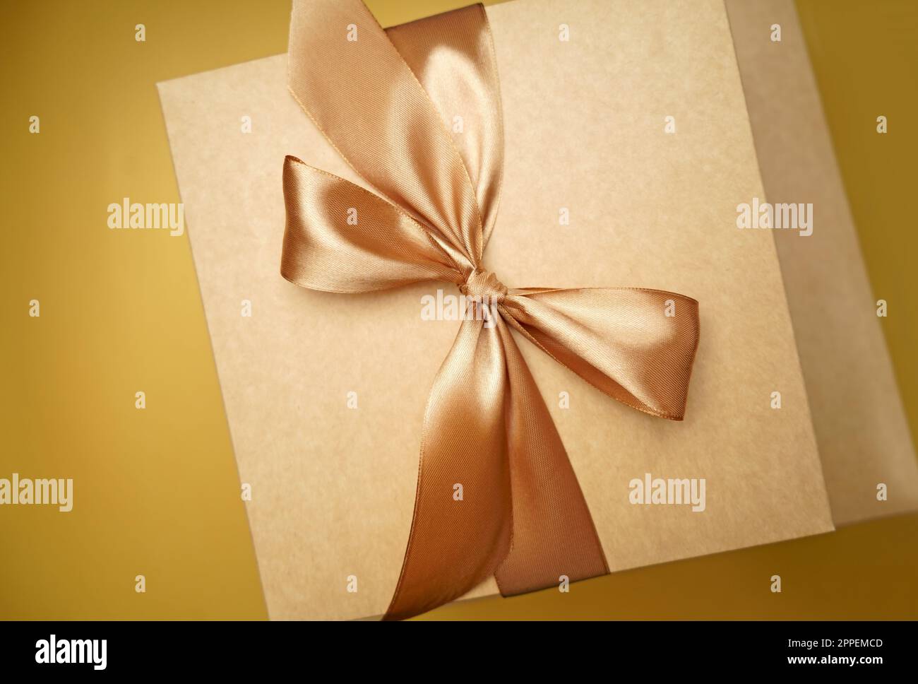 Square gift box. craft paper, yellow color bow knot, ribbons. paper ...
