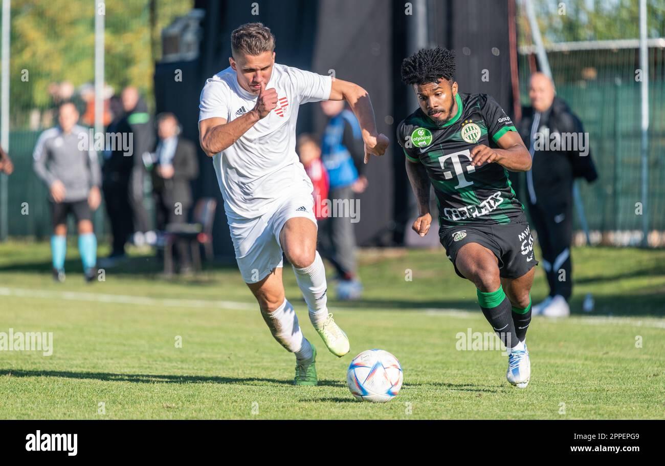 Ivancsa, Hungary – October 19, 2022. Ferencvaros striker Marquinhos and Ivancsa centre-back Nyilas Bence Istvan during Hungarian Cup Round of 32 match Stock Photo