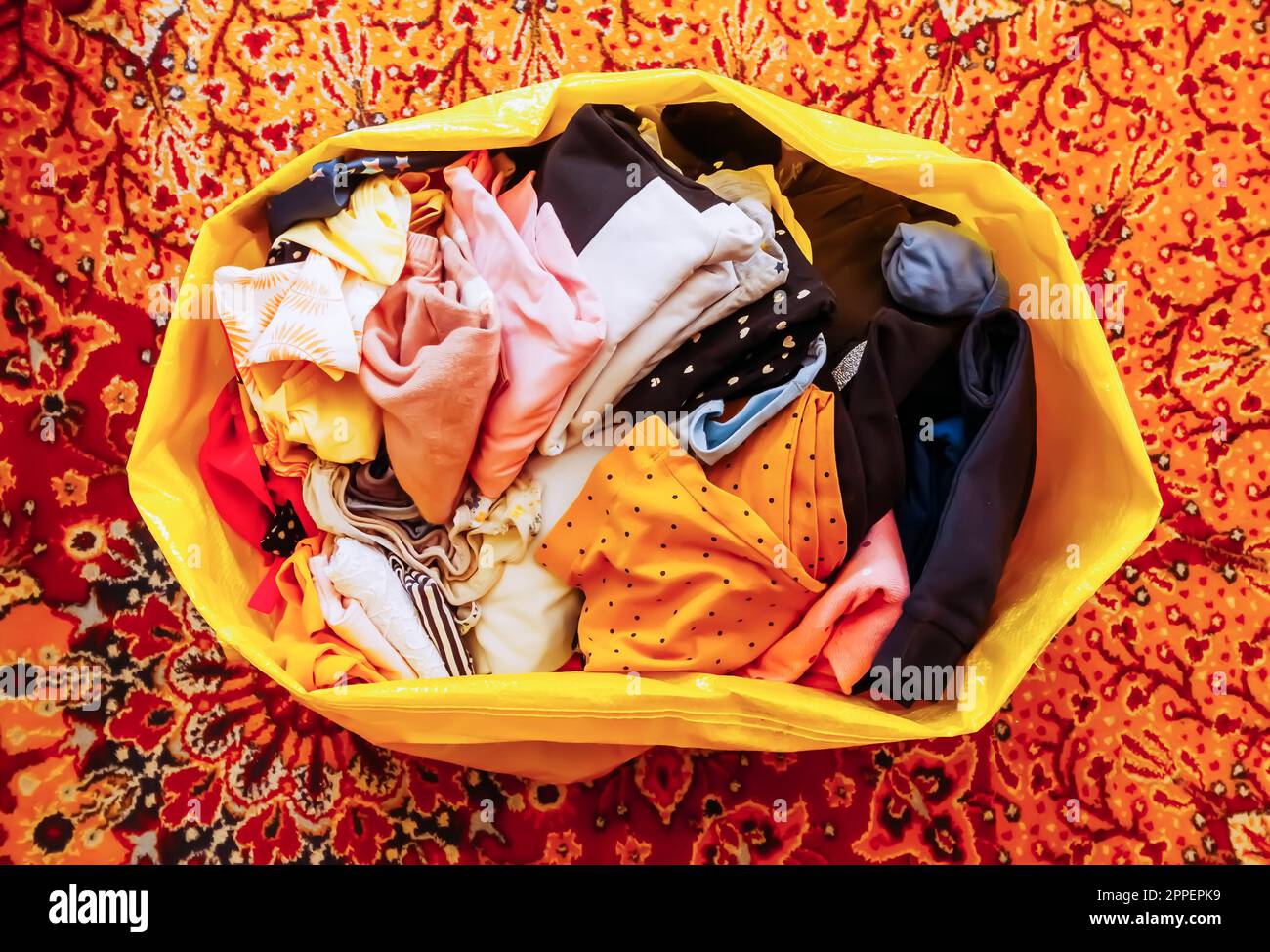 Plastic bag full of used clothes for charity or recycling Stock Photo