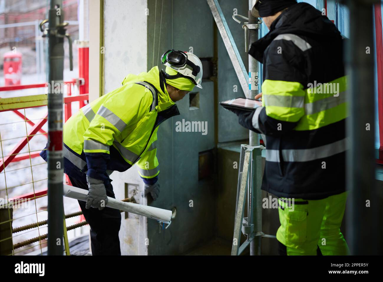 Male and female engineer working at construction site Stock Photo