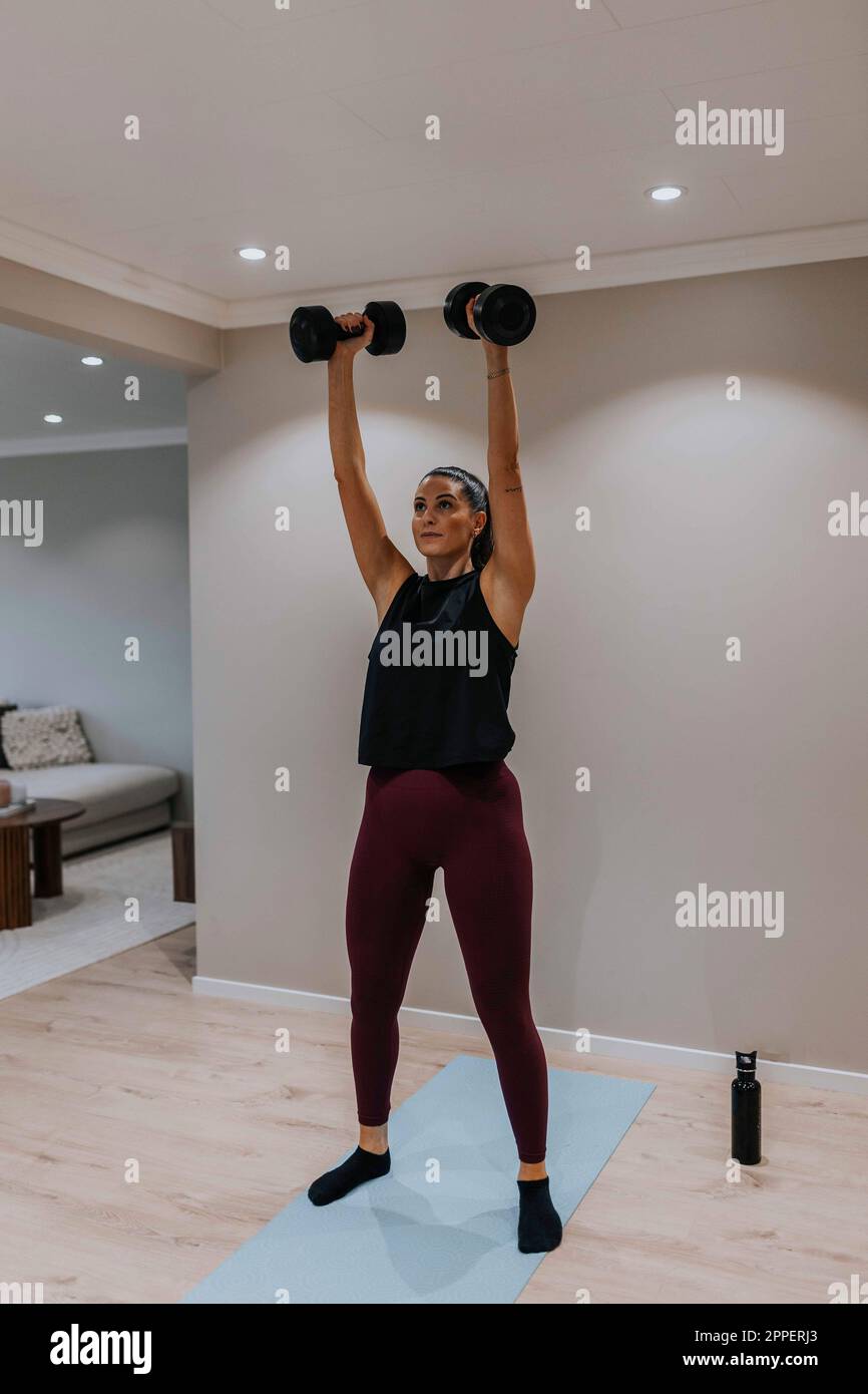 View of woman exercising at home Stock Photo