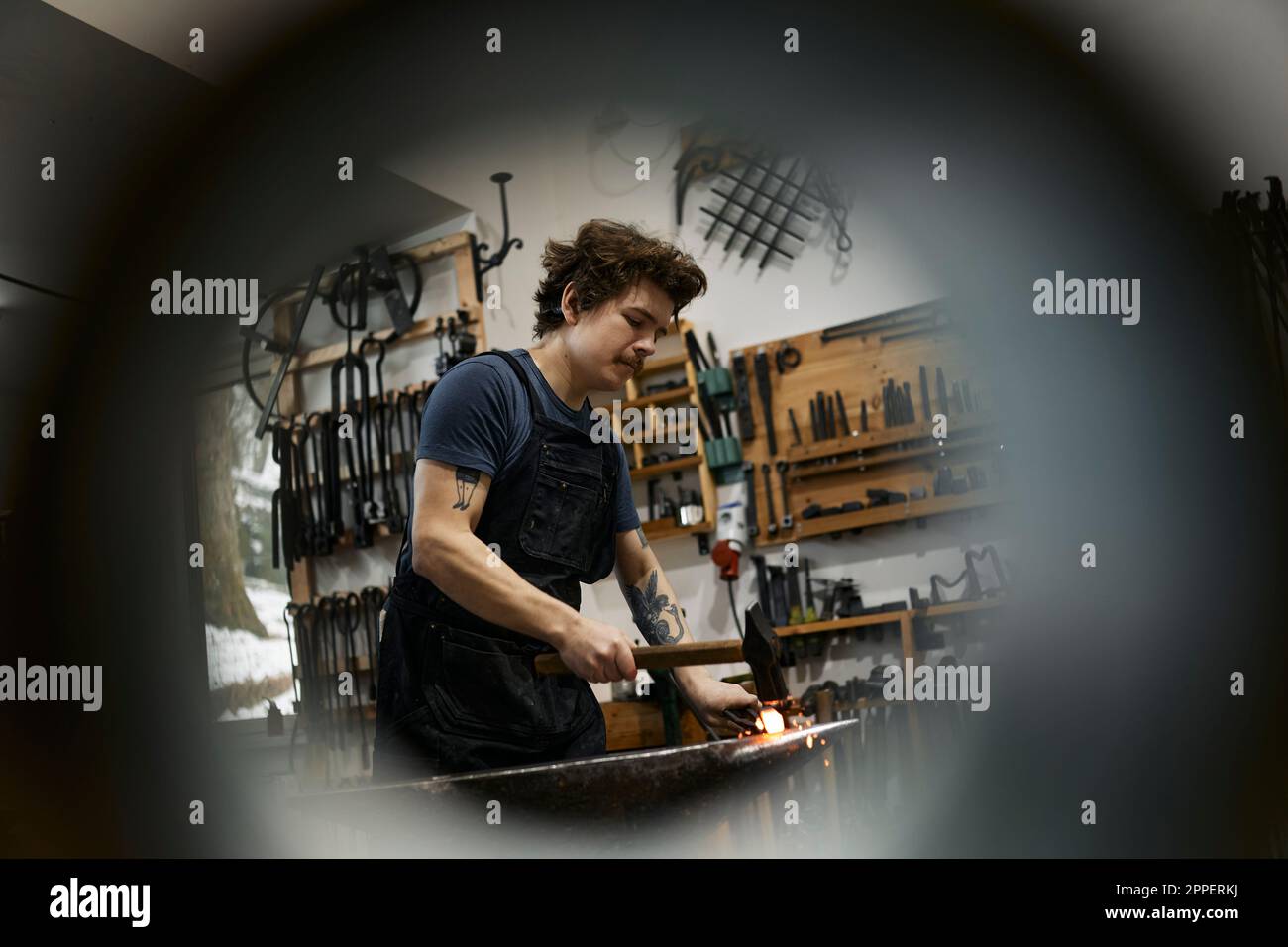 Blacksmith working in his workshop Stock Photo