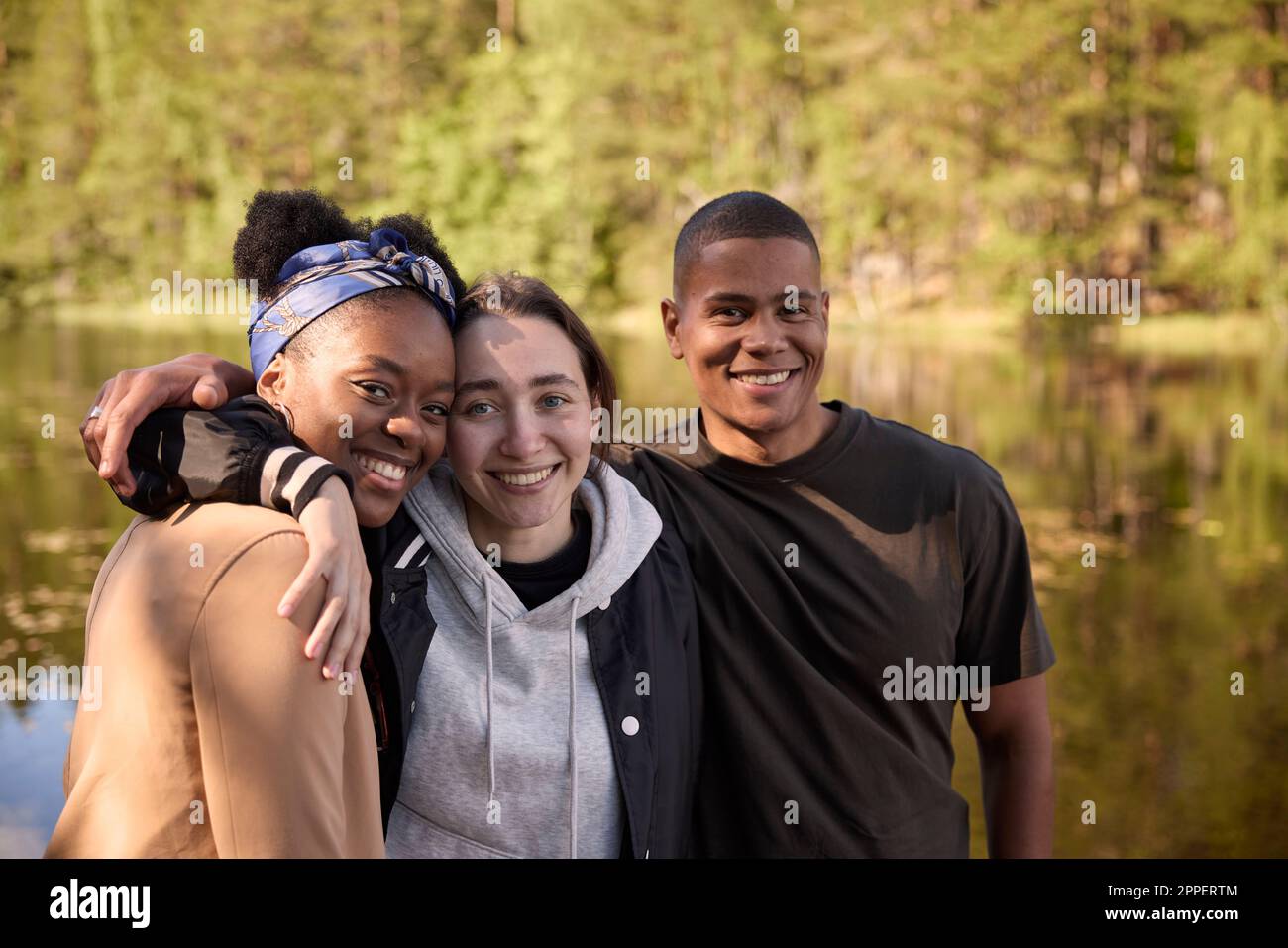 Smiling friends looking at camera Stock Photo