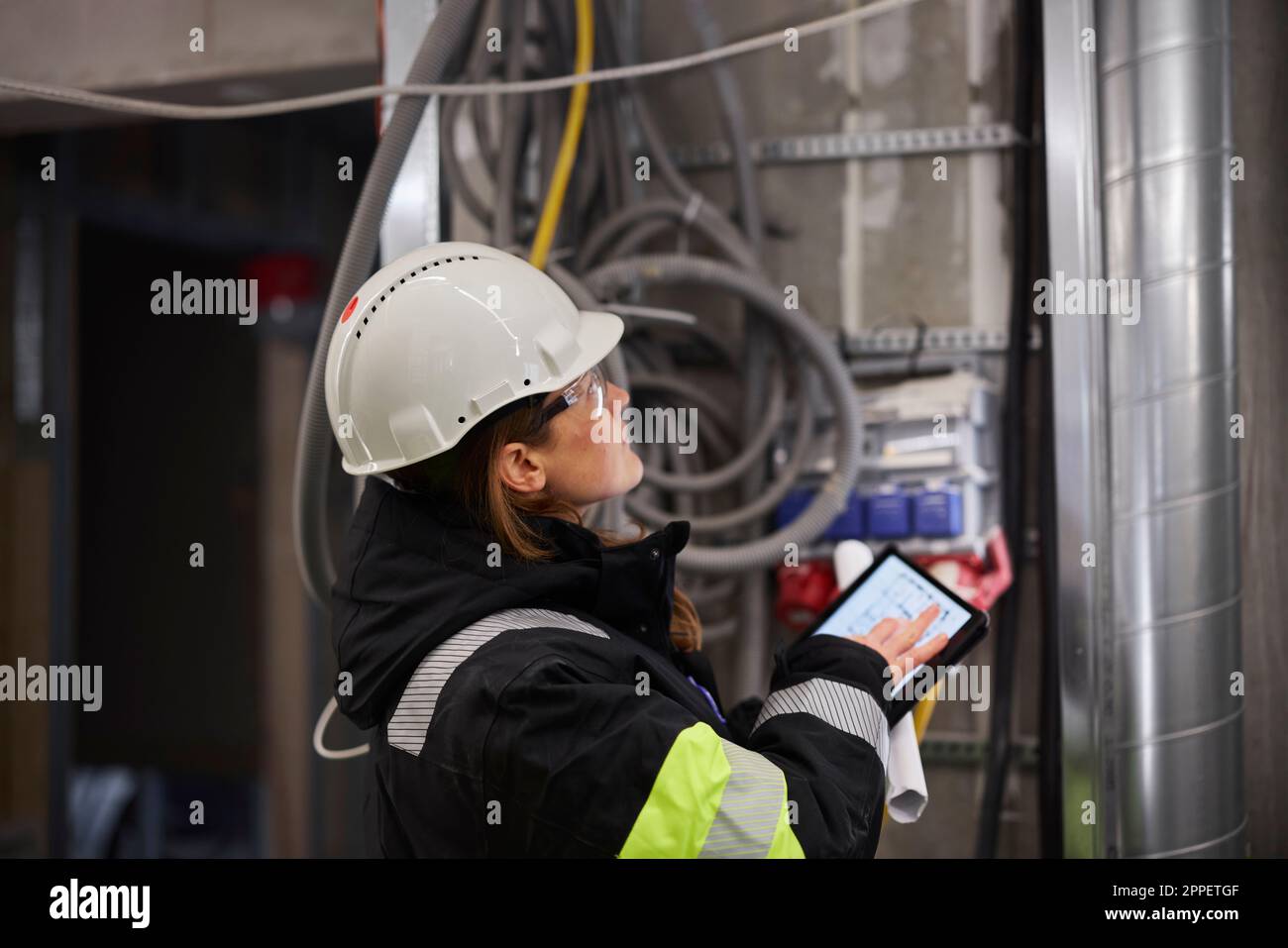 Female engineer using digital tablet at building site Stock Photo