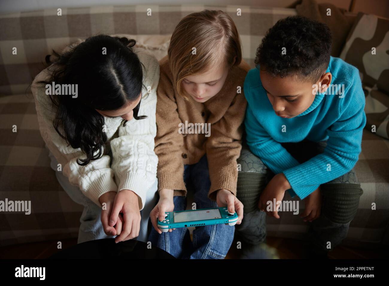 Children playing video games at home Stock Photo