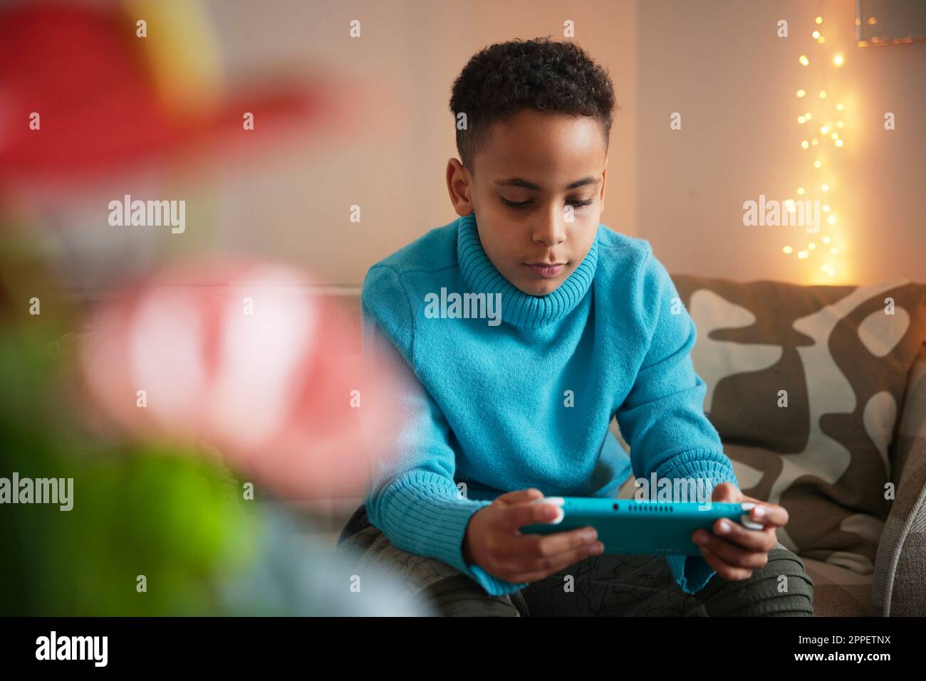 Boy playing video games at home Stock Photo