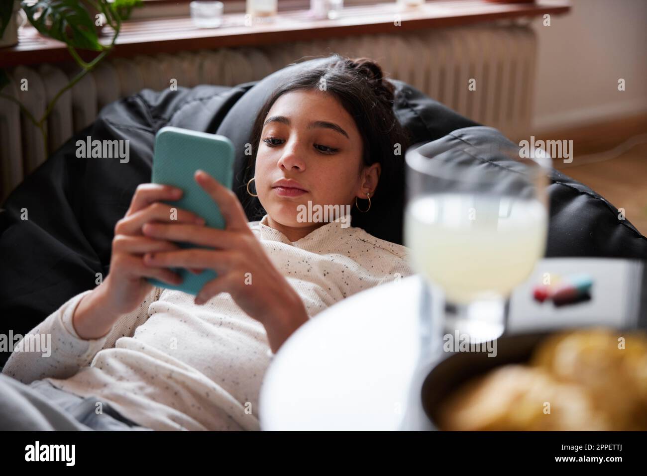 Girl lying on bean bag hi-res stock photography and images - Alamy