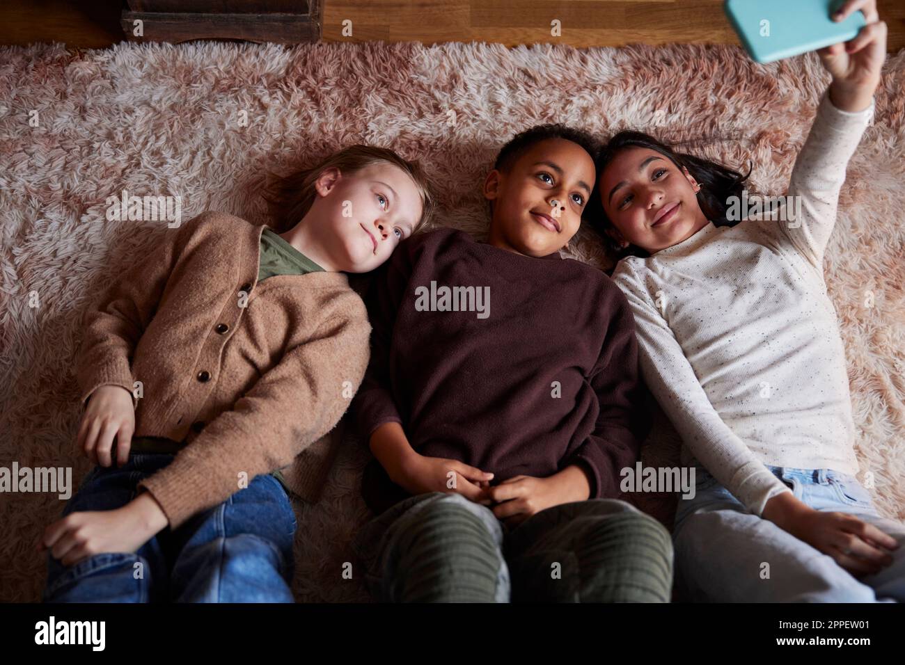 Children lying on floor hi-res stock photography and images - Alamy