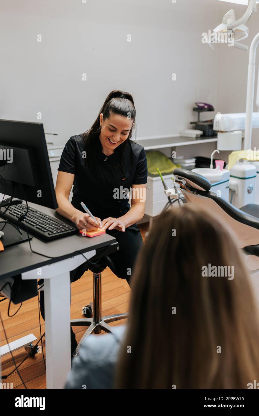 Female dentist using computer in office Stock Photo