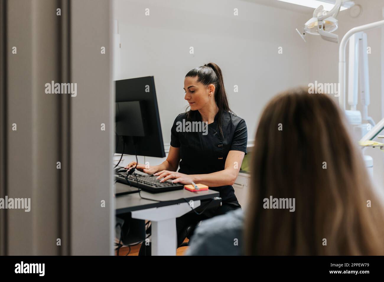 Female dentist using computer in office Stock Photo