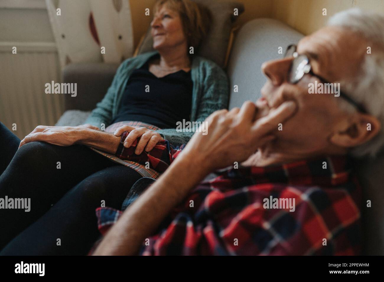 Senior couple relaxing on sofa Stock Photo