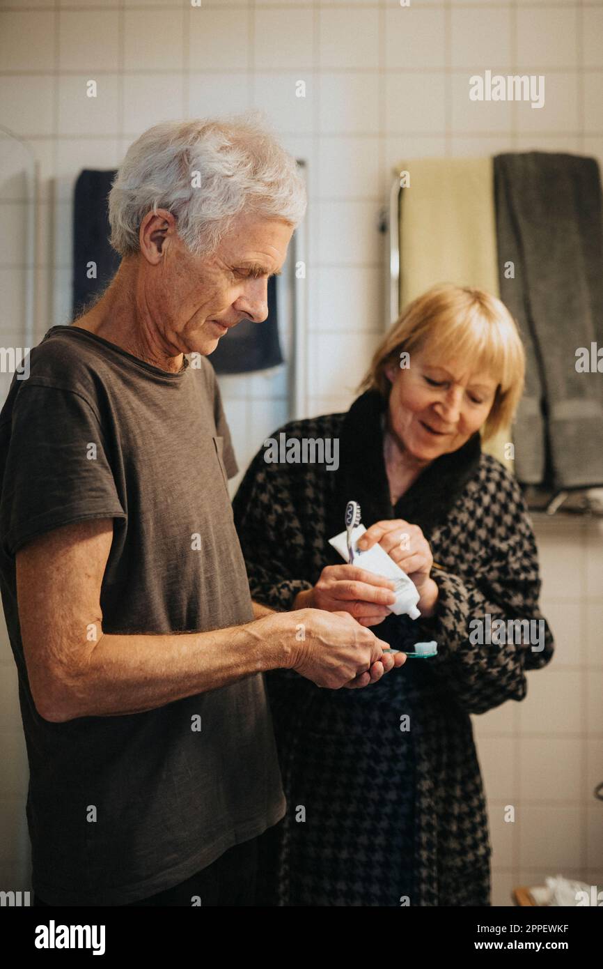 Senior couple brushing teeth at home Stock Photo