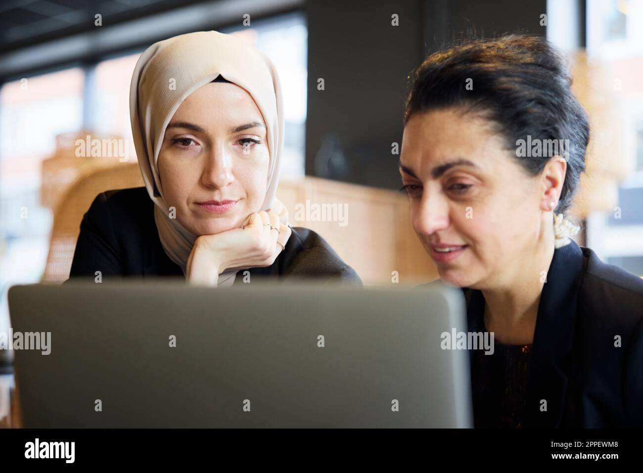Businesswomen using digital tablet in cafe Stock Photo