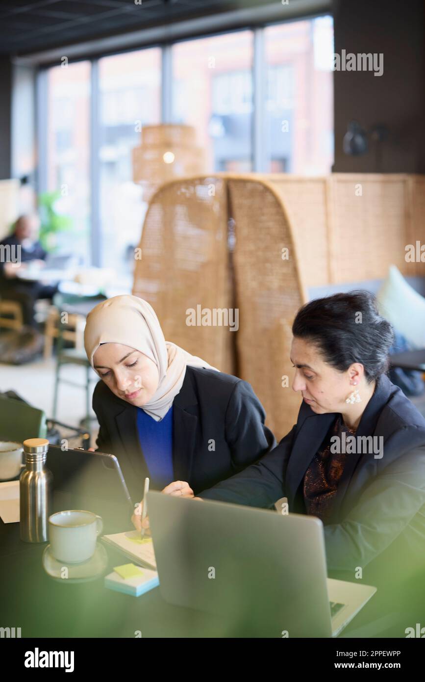 Businesswomen using digital tablet in cafe Stock Photo