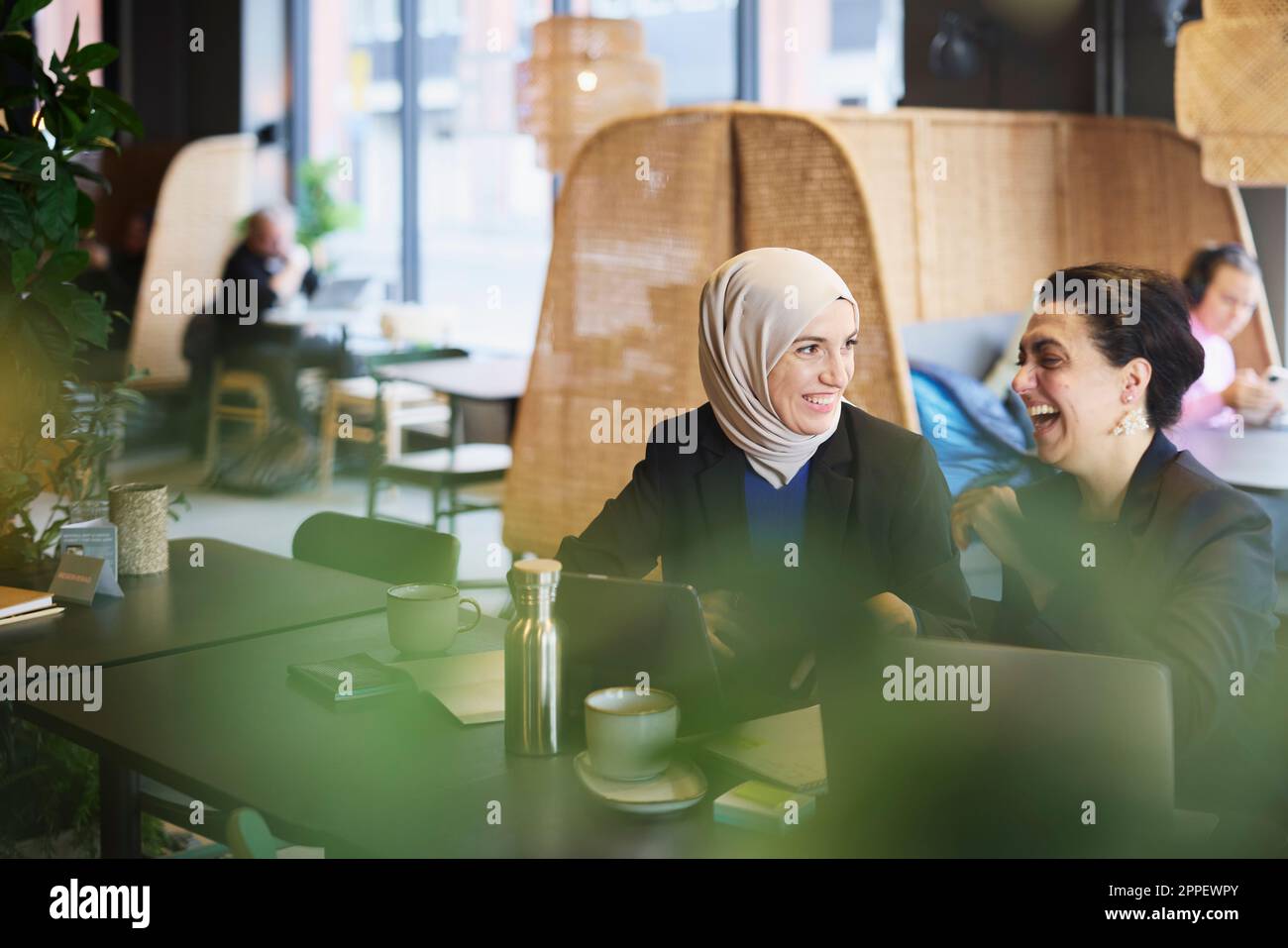 Businesswomen using digital tablet in cafe Stock Photo