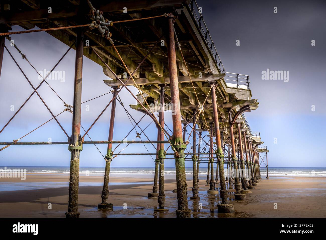 SaltburnbytheSea. On the beach looking up at the underneath of the old Victorian pier Stock