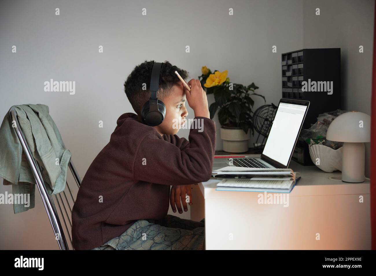 Boy doing homework with laptop Stock Photo