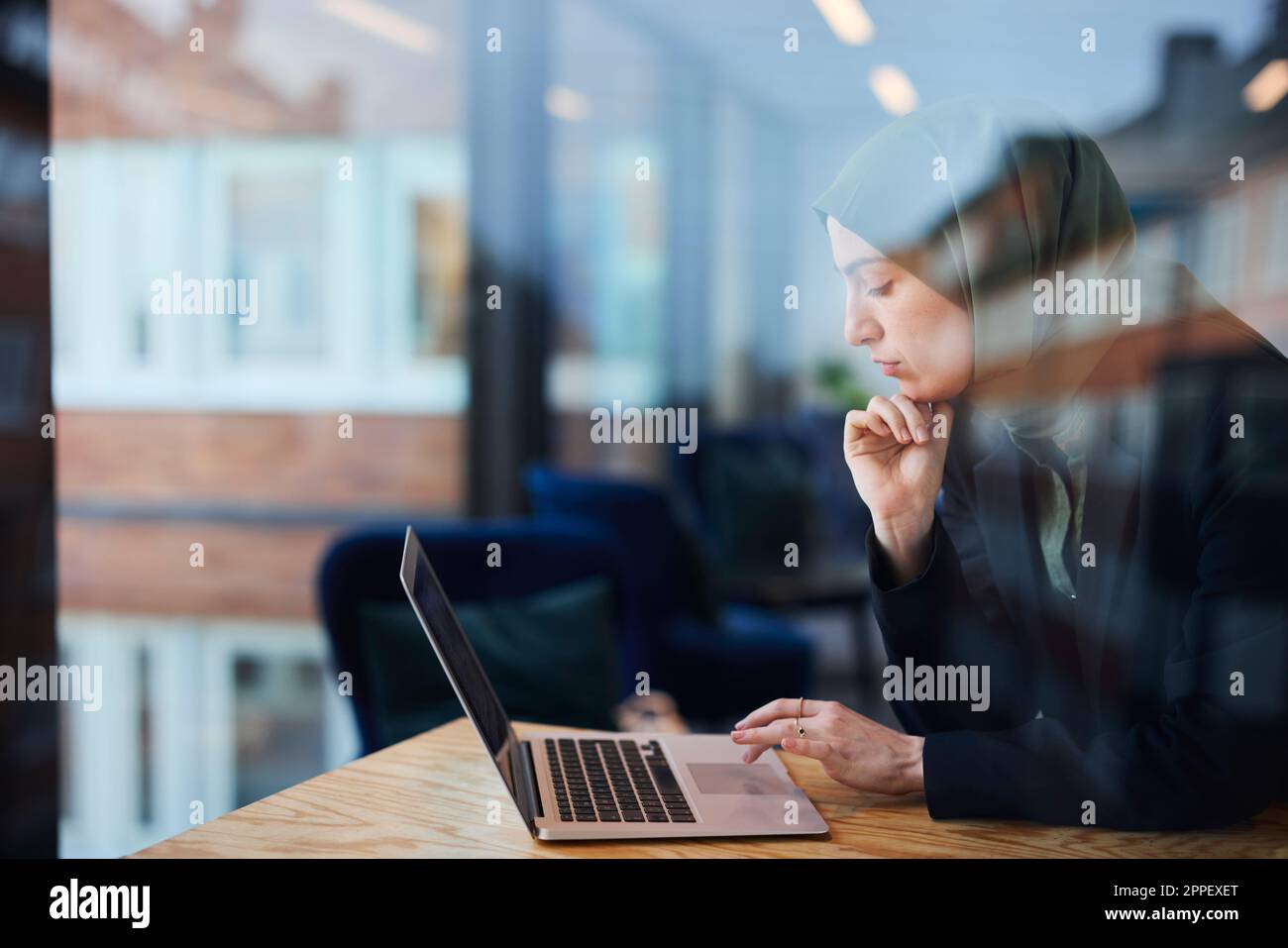 Woman in cafe using laptop Stock Photo