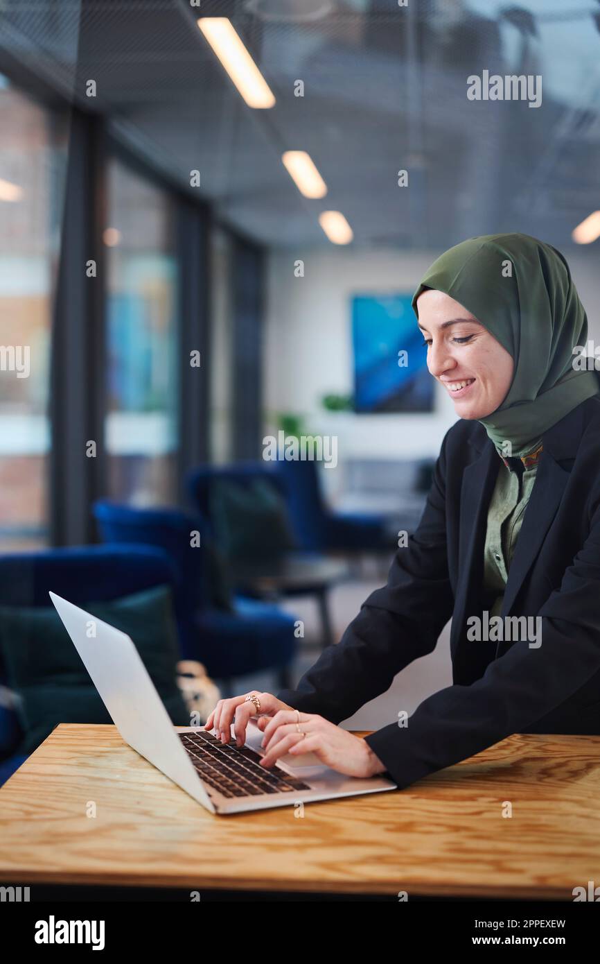 Woman in office using laptop Stock Photo