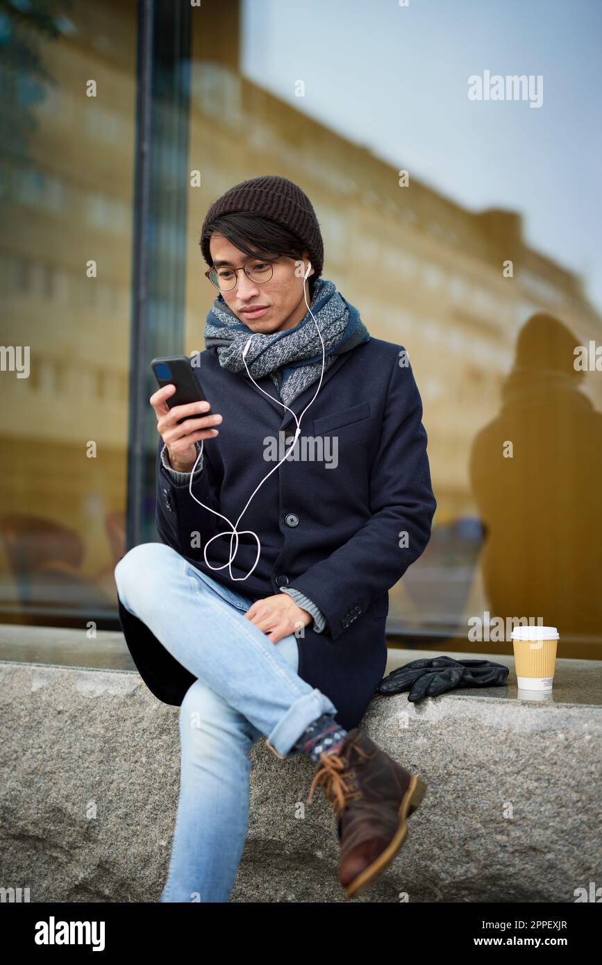 Smiling man using cell phone Stock Photo